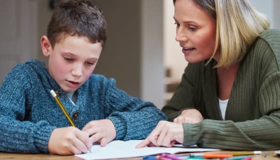 Woman helping her son with his school work